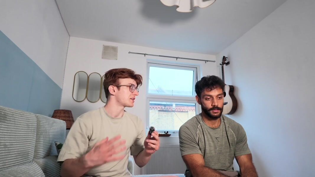 Elliott and Suryava on a sofa, talking